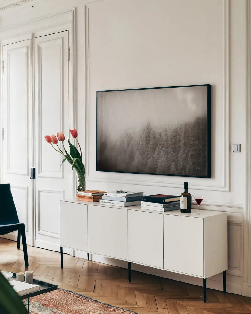 Northern Forests BW by Nathan Larson. shown as a framed stretched canvas in a living room above a console. Available as a archival giclee rolled canvas, fine art paper, or poster print. SKU 82413i.