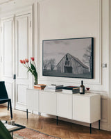 Old Hay Barn BW by Nathan Larson. shown as a framed stretched canvas in a living room above a console. Available as a archival giclee rolled canvas, fine art paper, or poster print. SKU 98032i.