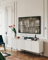 Old Trading Post by Nathan Larson. shown as a framed stretched canvas in a living room above a console. Available as a archival giclee rolled canvas, fine art paper, or poster print. SKU 99381i.