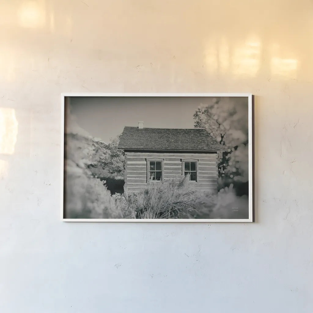 One Room Schoolhouse by Nathan Larson. shown as a paper print in a white frame. Available as a archival giclee rolled canvas, fine art paper, or poster print. SKU 95335i.