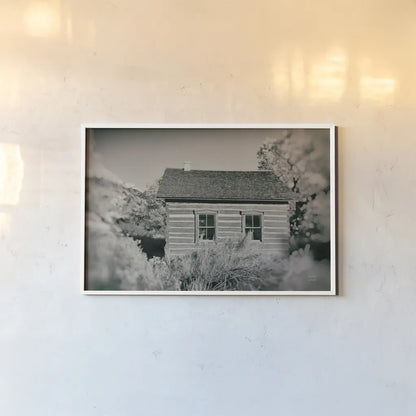 One Room Schoolhouse by Nathan Larson. shown as a paper print in a white frame. Available as a archival giclee rolled canvas, fine art paper, or poster print. SKU 95335i.