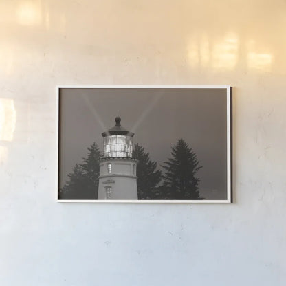 Oregon Coast Lighthouse by Nathan Larson. shown as a paper print in a white frame. Available as a archival giclee rolled canvas, fine art paper, or poster print. SKU 90172i.
