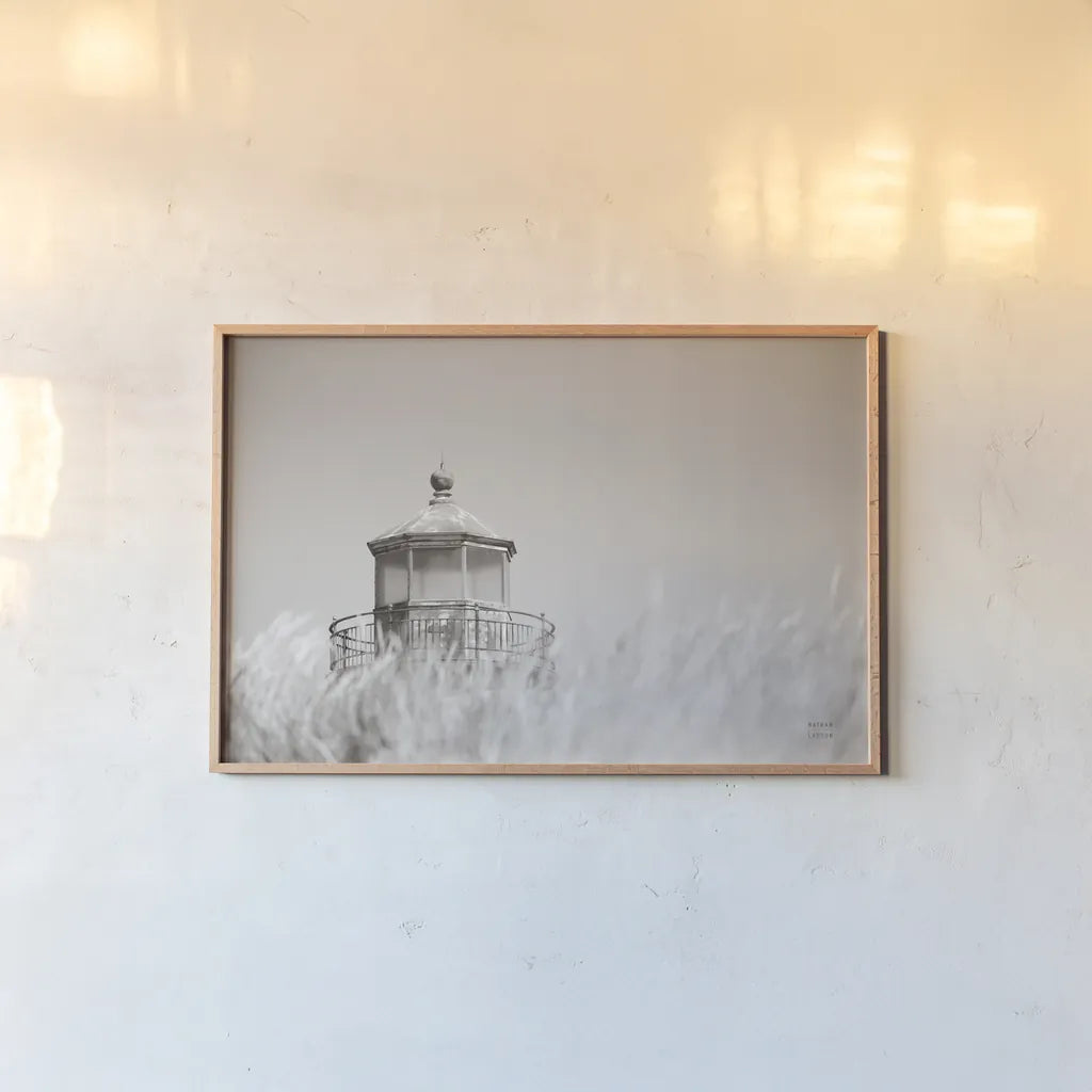 Oregon Coast Lighthouse Neutral by Nathan Larson. shown as a paper print in a natural frame. Available as a archival giclee rolled canvas, fine art paper, or poster print. SKU 86919i.