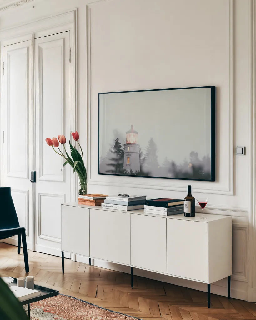 Oregon Coast Umpqua River Lighthouse by Nathan Larson. shown as a framed stretched canvas in a living room above a console. Available as a archival giclee rolled canvas, fine art paper, or poster print. SKU 87004i.