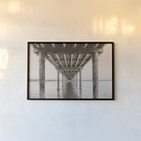 Pacific Pier by Nathan Larson. shown as a paper print in a black flame. Available as a archival giclee rolled canvas, fine art paper, or poster print. SKU 86918i.