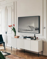 Prairie Church Solo Halo BW by Nathan Larson. shown as a framed stretched canvas in a living room above a console. Available as a archival giclee rolled canvas, fine art paper, or poster print. SKU 84240i.