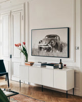 Punch Buggy BW by Nathan Larson. shown as a framed stretched canvas in a living room above a console. Available as a archival giclee rolled canvas, fine art paper, or poster print. SKU 103998i.