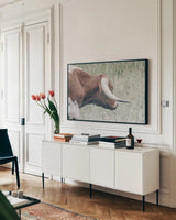 Raining Bull by Nathan Larson. shown as a framed stretched canvas in a living room above a console. Available as a archival giclee rolled canvas, fine art paper, or poster print. SKU 99207i.