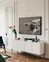 Rainy Pasture I BW by Nathan Larson. shown as a framed stretched canvas in a living room above a console. Available as a archival giclee rolled canvas, fine art paper, or poster print. SKU 99212i.