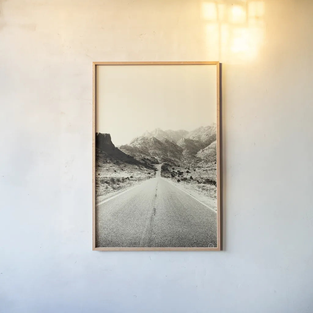 Road to Old West by Nathan Larson. shown as a paper print in a natural frame. Available as a archival giclee rolled canvas, fine art paper, or poster print. SKU 72028h.