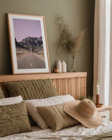 Road to Old West Purple by Nathan Larson. shown as a paper print in a natural frame. Available as a archival giclee rolled canvas, fine art paper, or poster print. SKU 79243h.