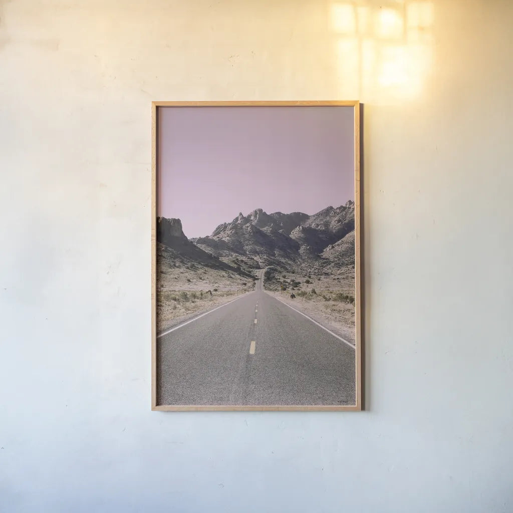 Road to Old West Purple by Nathan Larson. shown as a paper print in a natural frame. Available as a archival giclee rolled canvas, fine art paper, or poster print. SKU 79243h.