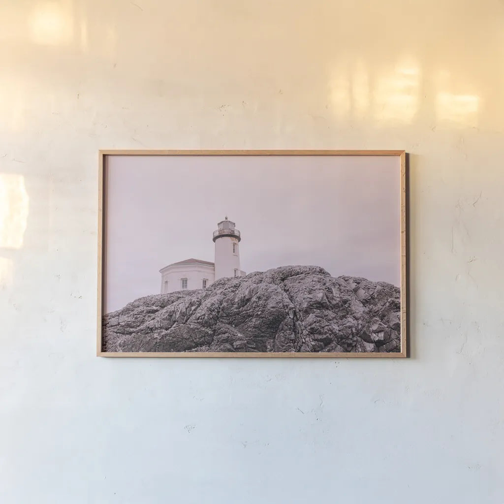 Rocky Lighthouse by Nathan Larson. shown as a paper print in a natural frame. Available as a archival giclee rolled canvas, fine art paper, or poster print. SKU 91851i.