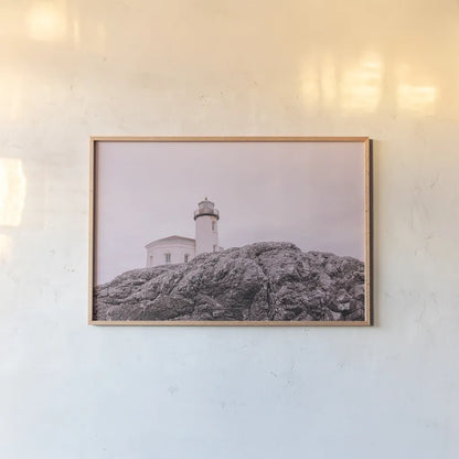 Rocky Lighthouse by Nathan Larson. shown as a paper print in a natural frame. Available as a archival giclee rolled canvas, fine art paper, or poster print. SKU 91851i.