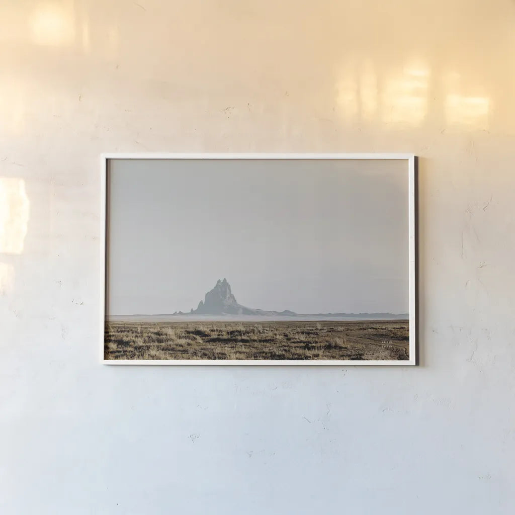Shiprock Fade by Nathan Larson. shown as a paper print in a white frame. Available as a archival giclee rolled canvas, fine art paper, or poster print. SKU 95336i.