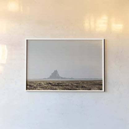 Shiprock Fade by Nathan Larson. shown as a paper print in a white frame. Available as a archival giclee rolled canvas, fine art paper, or poster print. SKU 95336i.