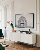 Sitting Still by Nathan Larson. shown as a framed stretched canvas in a living room above a console. Available as a archival giclee rolled canvas, fine art paper, or poster print. SKU 98508i.