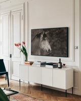 Snowy Range BW by Nathan Larson. shown as a framed stretched canvas in a living room above a console. Available as a archival giclee rolled canvas, fine art paper, or poster print. SKU 84268i.