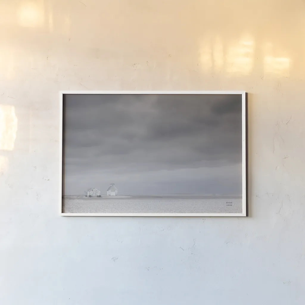 Storm Barn by Nathan Larson. shown as a paper print in a white frame. Available as a archival giclee rolled canvas, fine art paper, or poster print. SKU 80684i.