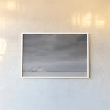Storm Barn by Nathan Larson. shown as a paper print in a white frame. Available as a archival giclee rolled canvas, fine art paper, or poster print. SKU 80684i.