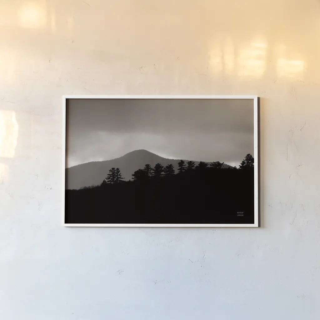 Storm Layers by Nathan Larson. shown as a paper print in a white frame. Available as a archival giclee rolled canvas, fine art paper, or poster print. SKU 79108i.