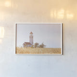Sunny Day Lighthouse by Nathan Larson. shown as a paper print in a white frame. Available as a archival giclee rolled canvas, fine art paper, or poster print. SKU 90176i.