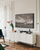 Sunny Pastures BW by Nathan Larson. shown as a framed stretched canvas in a living room above a console. Available as a archival giclee rolled canvas, fine art paper, or poster print. SKU 84242i.