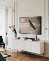 Sunray Eagle by Nathan Larson. shown as a framed stretched canvas in a living room above a console. Available as a archival giclee rolled canvas, fine art paper, or poster print. SKU 78764i.