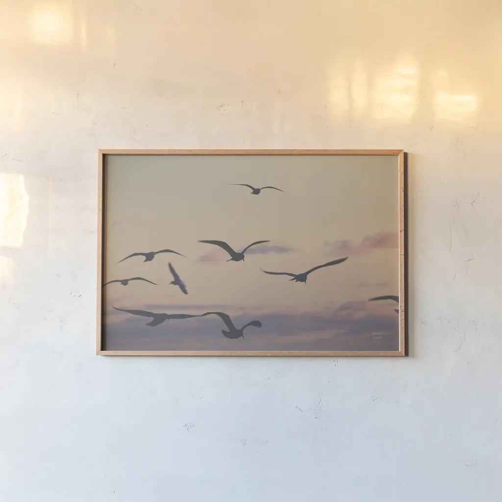 Sunset Flock by Nathan Larson. shown as a paper print in a natural frame. Available as a archival giclee rolled canvas, fine art paper, or poster print. SKU 85269i.
