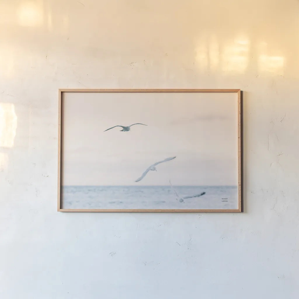 Sunset Flocks by Nathan Larson. shown as a paper print in a natural frame. Available as a archival giclee rolled canvas, fine art paper, or poster print. SKU 82386i.