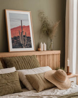Sunsets and Saguaros I by Nathan Larson. shown as a paper print in a natural frame. Available as a archival giclee rolled canvas, fine art paper, or poster print. SKU 76429h.