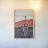 Sunsets and Saguaros I by Nathan Larson. shown as a paper print in a natural frame. Available as a archival giclee rolled canvas, fine art paper, or poster print. SKU 76429h.