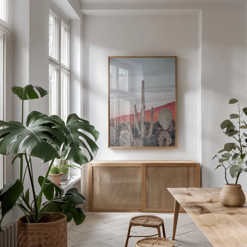 Sunsets and Saguaros II by Nathan Larson. shown as a print in a natural wood frame in a dining room. Available as a archival giclee rolled canvas, fine art paper, or poster print. SKU 76430h.