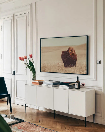 Tall Grass Bison I by Nathan Larson. shown as a framed stretched canvas in a living room above a console. Available as a archival giclee rolled canvas, fine art paper, or poster print. SKU 86065i.