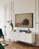 Tall Grass Bison II by Nathan Larson. shown as a framed stretched canvas in a living room above a console. Available as a archival giclee rolled canvas, fine art paper, or poster print. SKU 86066i.