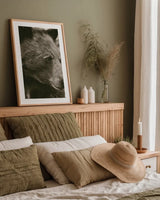 Thoughtful Bear Sepia by Nathan Larson. shown as a paper print in a natural frame. Available as a archival giclee rolled canvas, fine art paper, or poster print. SKU 100759h.