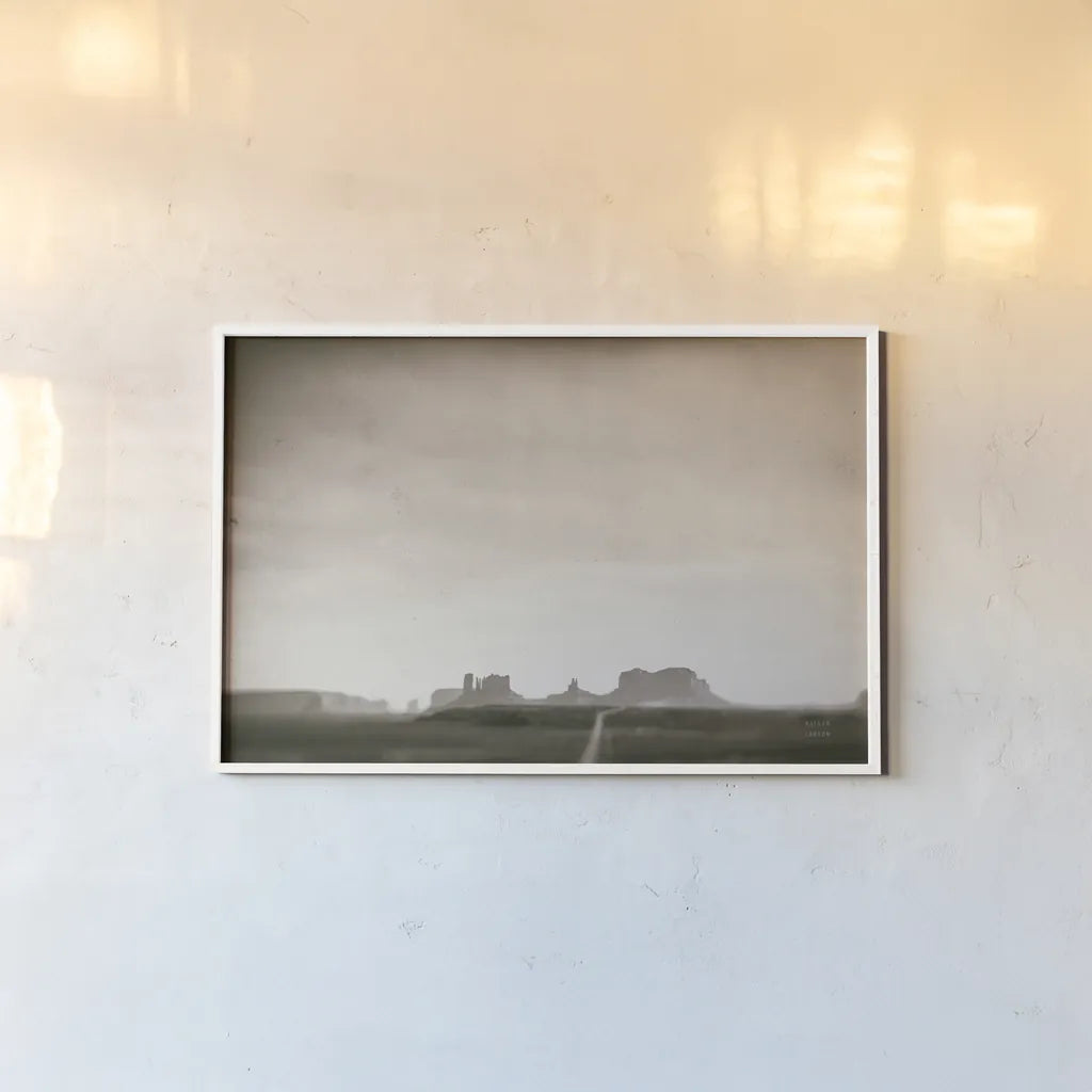 Timeless Monument Valley by Nathan Larson. shown as a paper print in a white frame. Available as a archival giclee rolled canvas, fine art paper, or poster print. SKU 87106i.