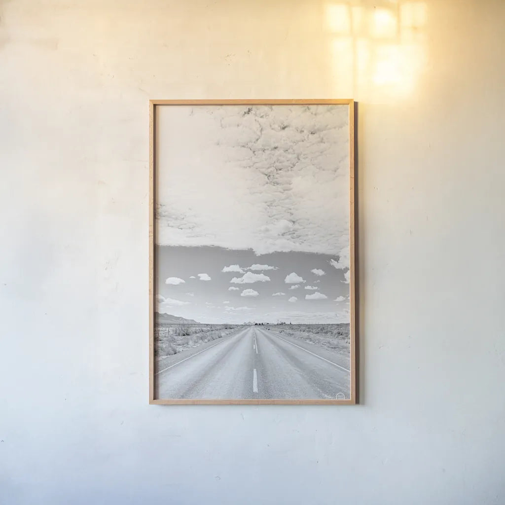 Tres Hermanas Clouds by Nathan Larson. shown as a paper print in a natural frame. Available as a archival giclee rolled canvas, fine art paper, or poster print. SKU 73735h.
