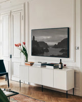 Twillingate Coast BW by Nathan Larson. shown as a framed stretched canvas in a living room above a console. Available as a archival giclee rolled canvas, fine art paper, or poster print. SKU 103184i.