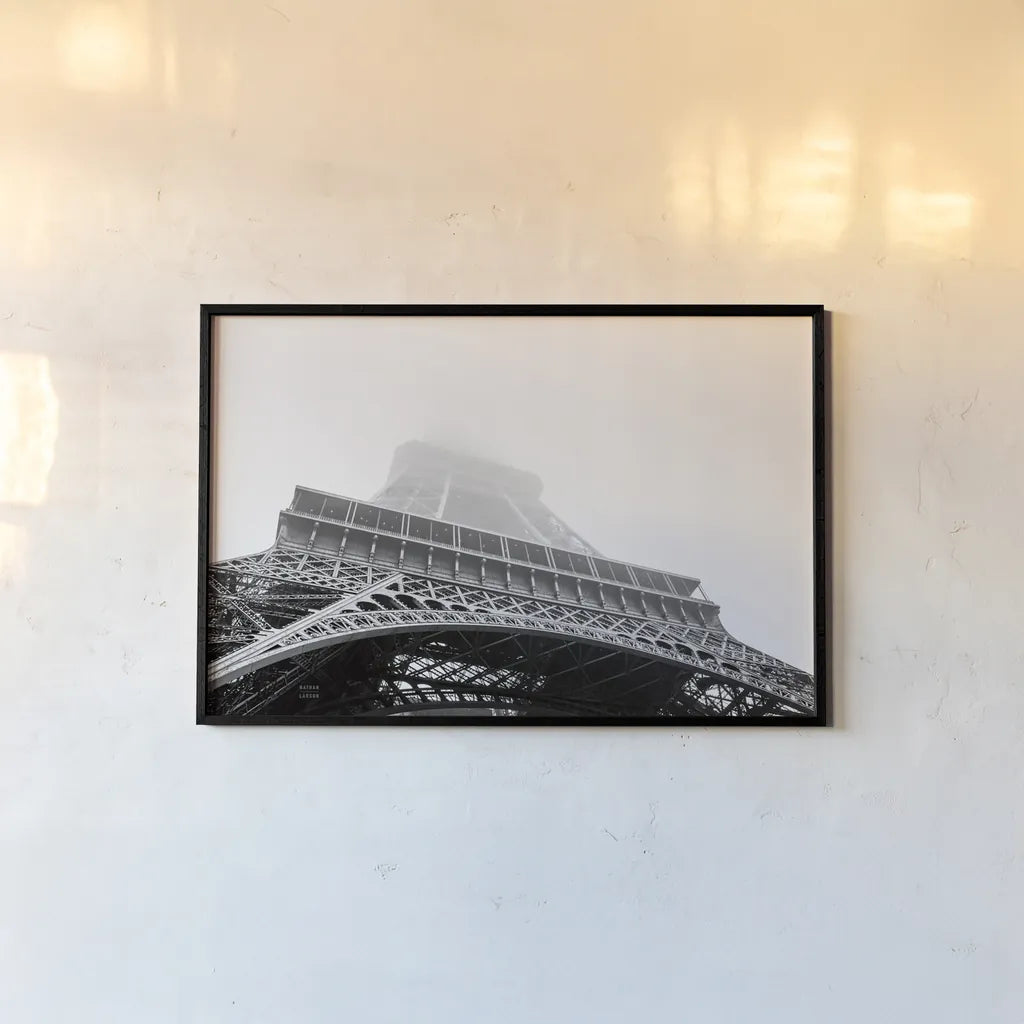 Under Eiffel Misty Day by Nathan Larson. shown as a paper print in a black flame. Available as a archival giclee rolled canvas, fine art paper, or poster print. SKU 82299i.