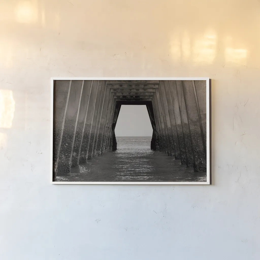 Under the Pier by Nathan Larson. shown as a paper print in a white frame. Available as a archival giclee rolled canvas, fine art paper, or poster print. SKU 97580i.
