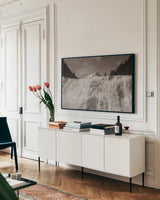 Wapta Falls by Nathan Larson. shown as a framed stretched canvas in a living room above a console. Available as a archival giclee rolled canvas, fine art paper, or poster print. SKU 103024i.