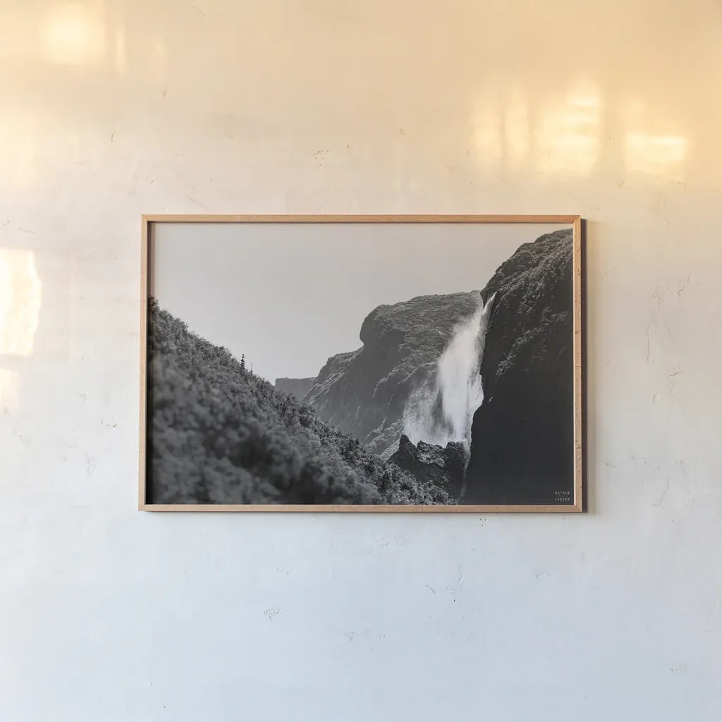Western Brook Pond Falls BW by Nathan Larson. shown as a paper print in a natural frame. Available as a archival giclee rolled canvas, fine art paper, or poster print. SKU 101659i.