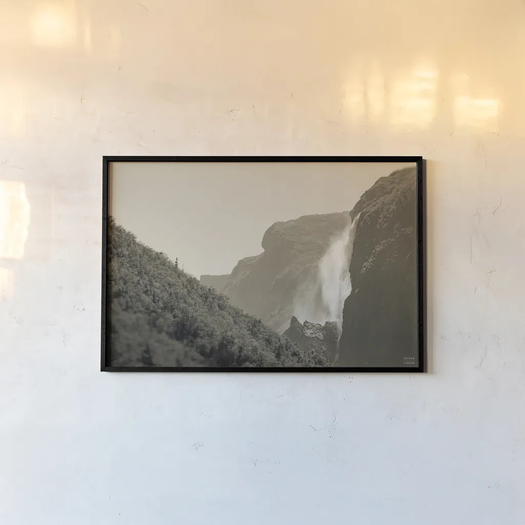 Western Brook Pond Falls Sepia by Nathan Larson. shown as a paper print in a black flame. Available as a archival giclee rolled canvas, fine art paper, or poster print. SKU 101658i.