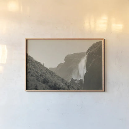 Western Brook Pond Falls Sepia by Nathan Larson. shown as a paper print in a natural frame. Available as a archival giclee rolled canvas, fine art paper, or poster print. SKU 101658i.