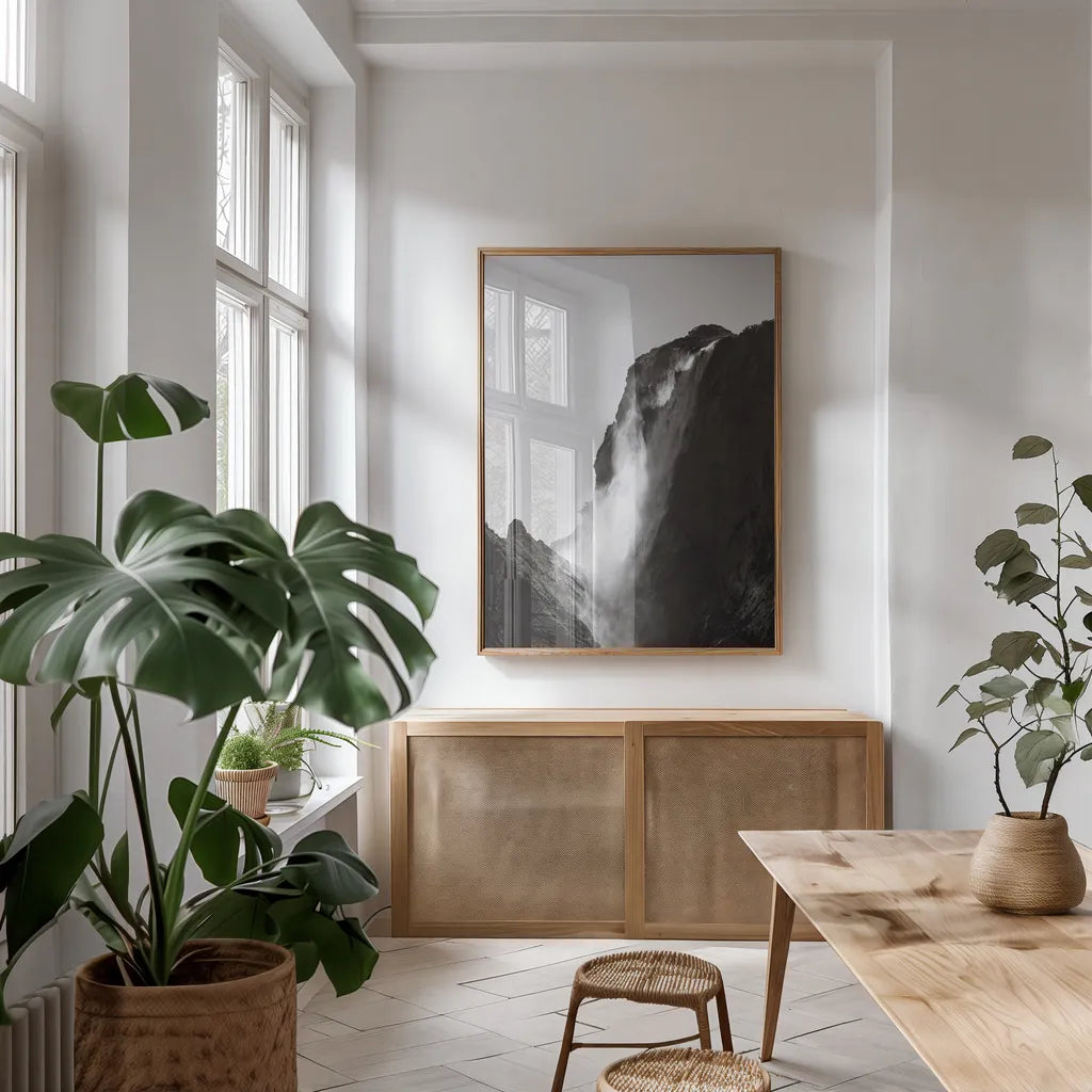 Western Brook Pond Waterfall by Nathan Larson. shown as a print in a natural wood frame in a dining room. Available as a archival giclee rolled canvas, fine art paper, or poster print. SKU 100501h.