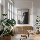 Western Brook Pond Waterfall by Nathan Larson. shown as a print in a natural wood frame in a dining room. Available as a archival giclee rolled canvas, fine art paper, or poster print. SKU 100501h.