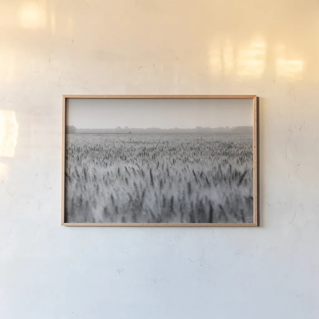Wheat in Summer BW by Nathan Larson. shown as a paper print in a natural frame. Available as a archival giclee rolled canvas, fine art paper, or poster print. SKU 101592i.