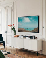 When Sea Becomes Sky by Nathan Larson. shown as a framed stretched canvas in a living room above a console. Available as a archival giclee rolled canvas, fine art paper, or poster print. SKU 88868i.