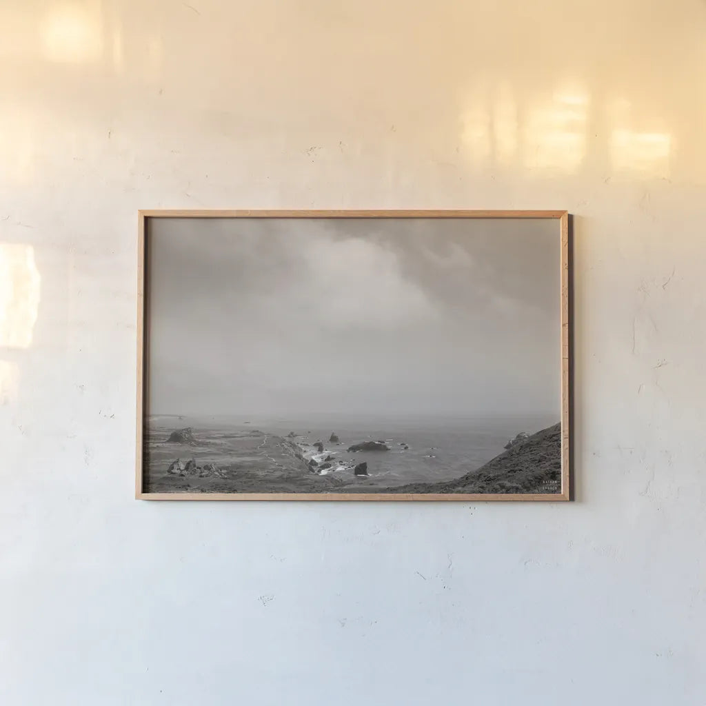 When Sea Becomes Sky BW by Nathan Larson. shown as a paper print in a natural frame. Available as a archival giclee rolled canvas, fine art paper, or poster print. SKU 88869i.